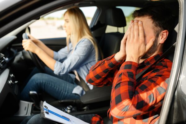 woman-and-scared-instructor-in-car-driving-school-2021-08-28-20-00-46-utc-600x399